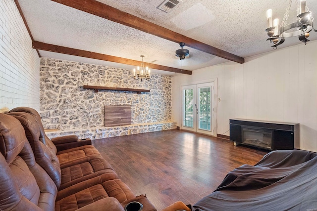 living room featuring beam ceiling, french doors, a textured ceiling, dark hardwood / wood-style floors, and a fireplace