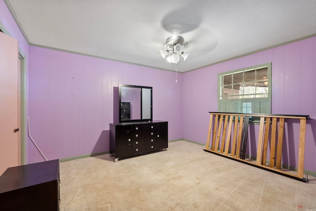 carpeted bedroom featuring ceiling fan, a textured ceiling, and wooden walls