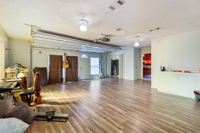 interior space featuring hardwood / wood-style flooring and a textured ceiling