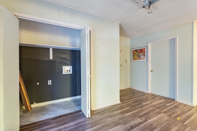 interior space with a closet, ornamental molding, hardwood / wood-style flooring, and a textured ceiling