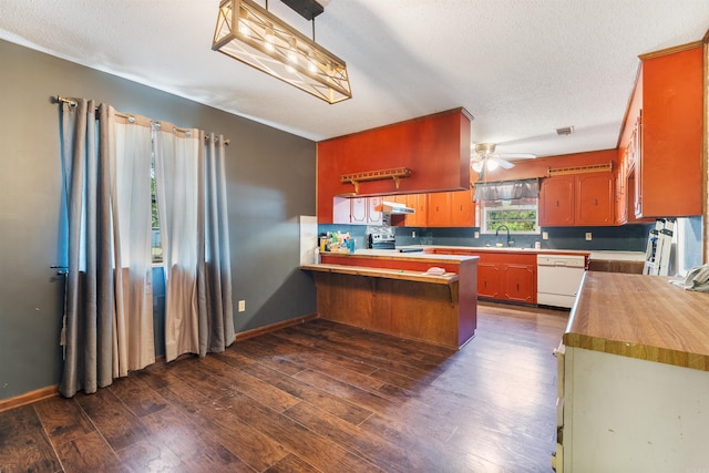 kitchen featuring stainless steel electric range, dark wood-type flooring, dishwasher, kitchen peninsula, and a textured ceiling