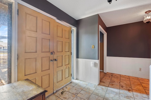 foyer with a textured ceiling