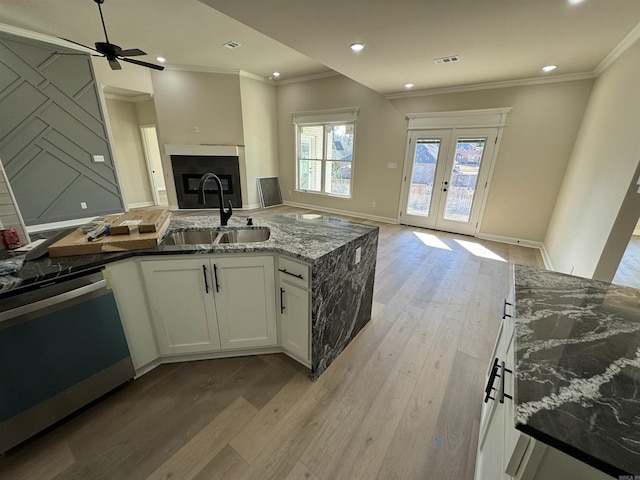 312 Forest Glen Cv, Jacksonville, AR 72076 - kitchen featuring stone countertops, open floor plan, visible vents, dishwashing machine, and a sink