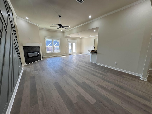 312 Forest Glen Cv, Jacksonville, AR 72076 - unfurnished living room featuring a tile fireplace, baseboards, ornamental molding, and ceiling fan