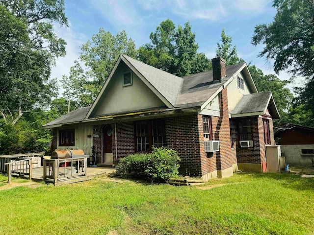 view of front facade with a front yard and cooling unit