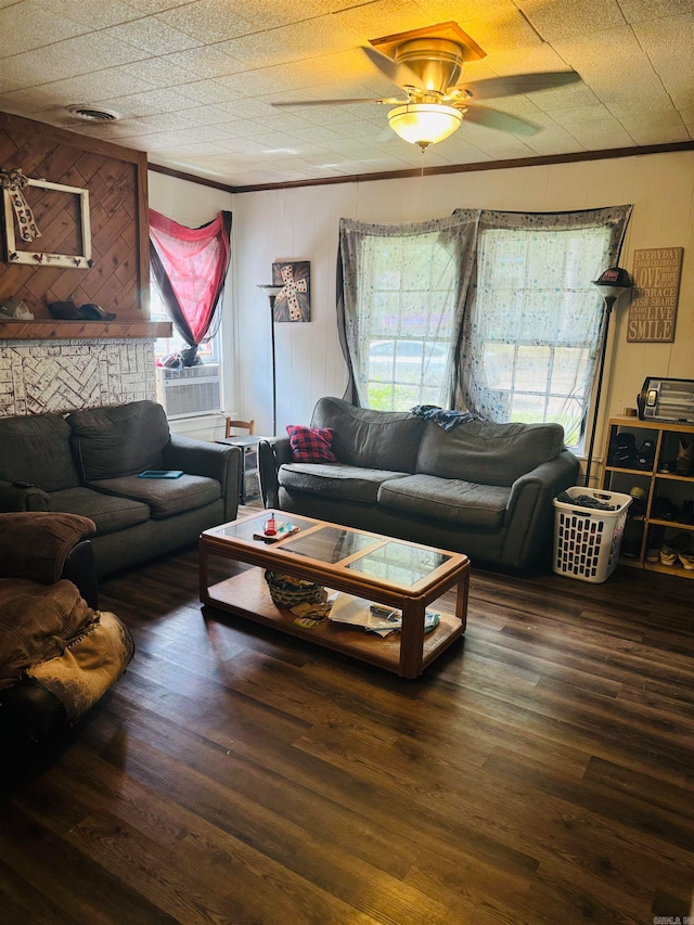 living room with ceiling fan, wooden walls, plenty of natural light, and dark wood-type flooring