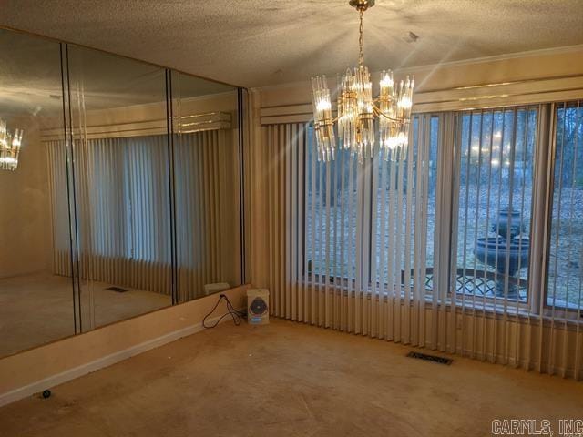 spare room with a textured ceiling and carpet