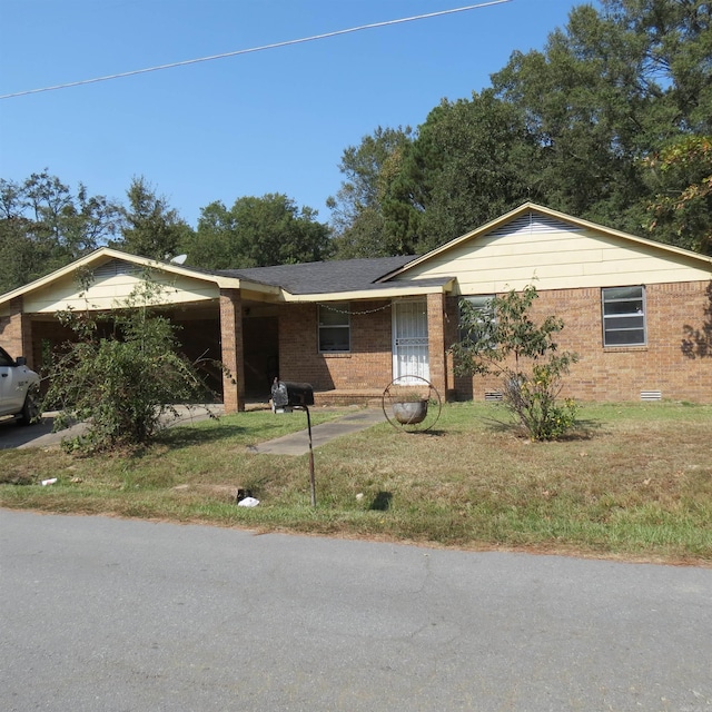 ranch-style house featuring a carport and a front yard