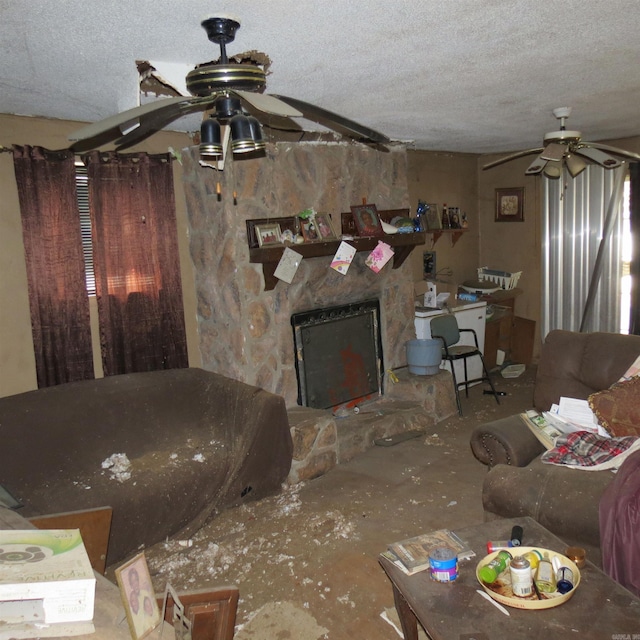 living room featuring ceiling fan, a textured ceiling, and a fireplace