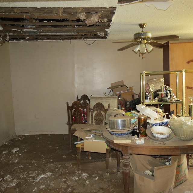 dining space with concrete flooring and ceiling fan