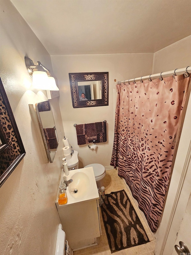 bathroom featuring vanity, tile patterned floors, curtained shower, and toilet