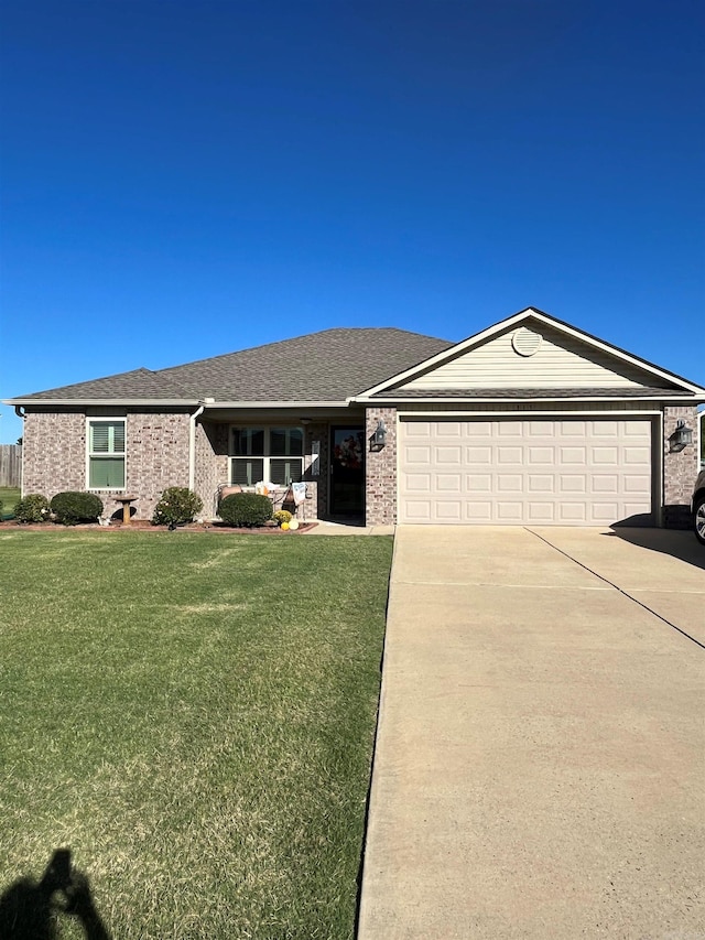 single story home with a garage and a front yard