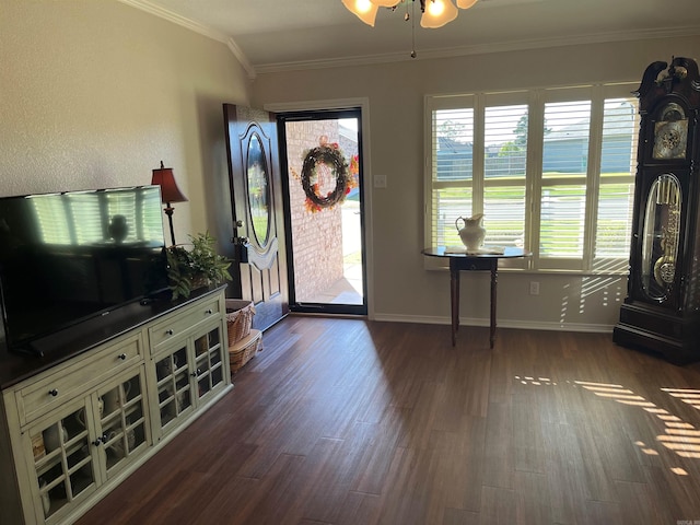 entrance foyer with ornamental molding, ceiling fan, and dark wood-type flooring