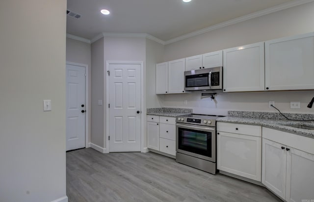 kitchen featuring light stone counters, white cabinets, crown molding, light hardwood / wood-style flooring, and appliances with stainless steel finishes