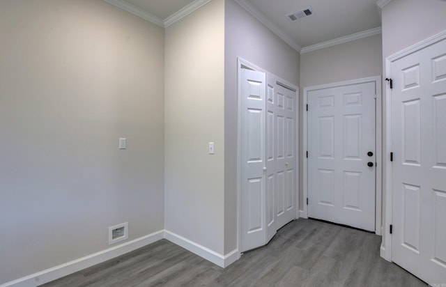 hallway featuring light hardwood / wood-style flooring and ornamental molding