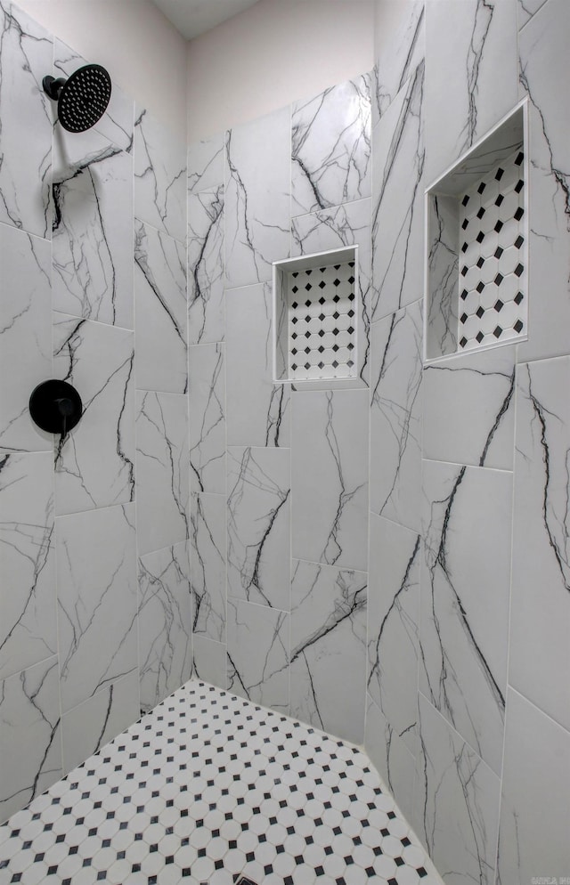 interior details featuring tiled shower