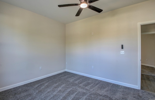 unfurnished room with dark colored carpet