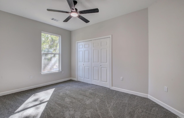 unfurnished bedroom featuring carpet floors, a closet, and ceiling fan