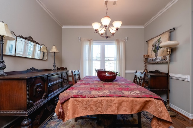 bedroom featuring ornamental molding, hardwood / wood-style floors, and a chandelier