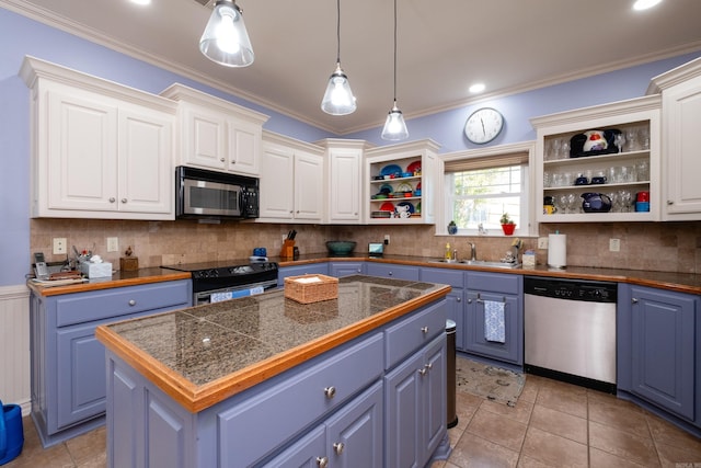 kitchen featuring blue cabinets, white cabinets, appliances with stainless steel finishes, and a center island