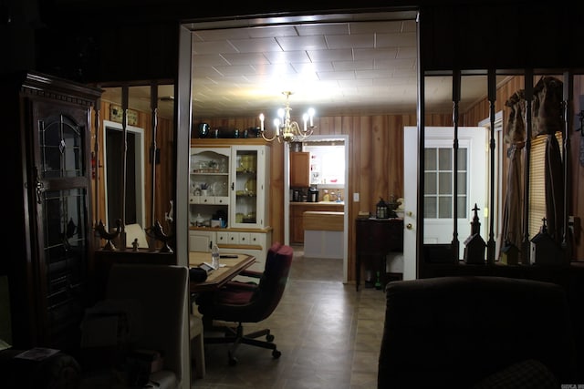 office featuring wood walls and a chandelier