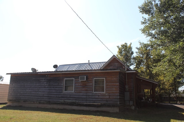 view of side of home with a lawn