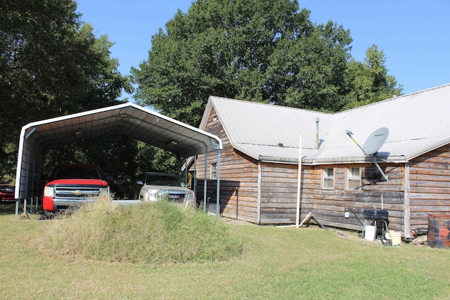 exterior space with a carport and a lawn