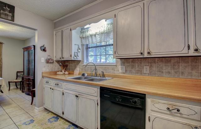 kitchen with tasteful backsplash, dishwasher, sink, light tile patterned floors, and a textured ceiling