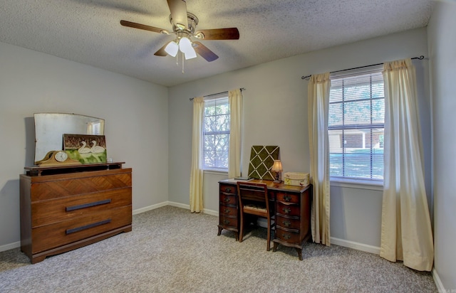 carpeted office with ceiling fan and a textured ceiling