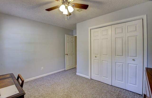 unfurnished bedroom featuring a closet, a textured ceiling, and ceiling fan