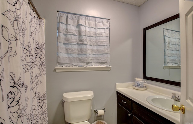 bathroom with vanity, toilet, and a shower with shower curtain