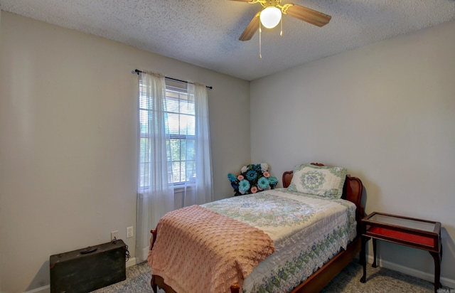 bedroom featuring ceiling fan, a textured ceiling, and carpet