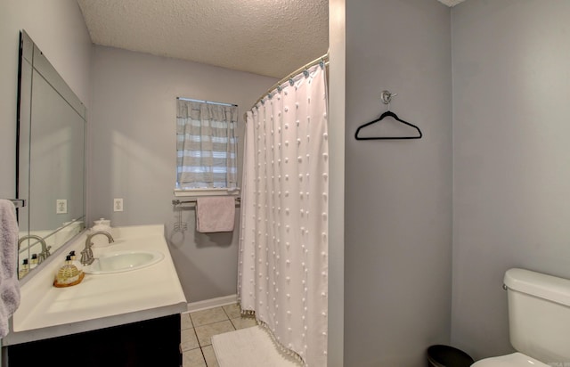 bathroom featuring tile patterned flooring, toilet, curtained shower, vanity, and a textured ceiling