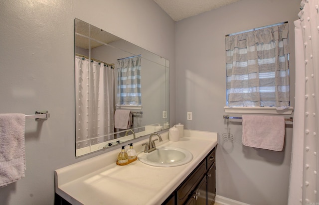 bathroom with vanity and a textured ceiling