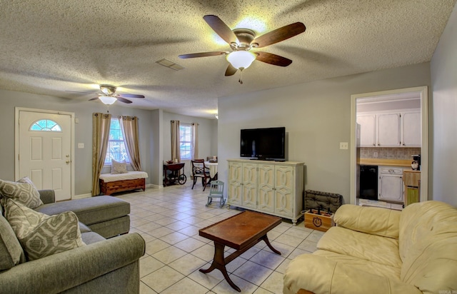 tiled living room featuring ceiling fan and a textured ceiling