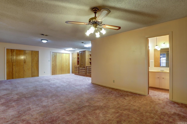 spare room with carpet floors, sink, a textured ceiling, and ceiling fan