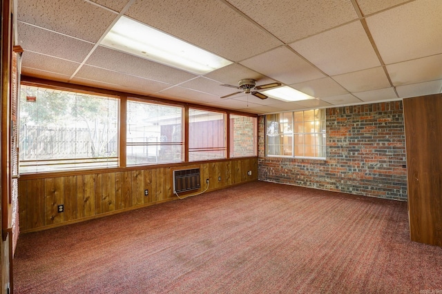 interior space featuring ceiling fan, a paneled ceiling, and a wall mounted air conditioner