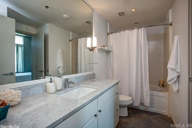 full bathroom featuring shower / bath combo, vanity, and toilet