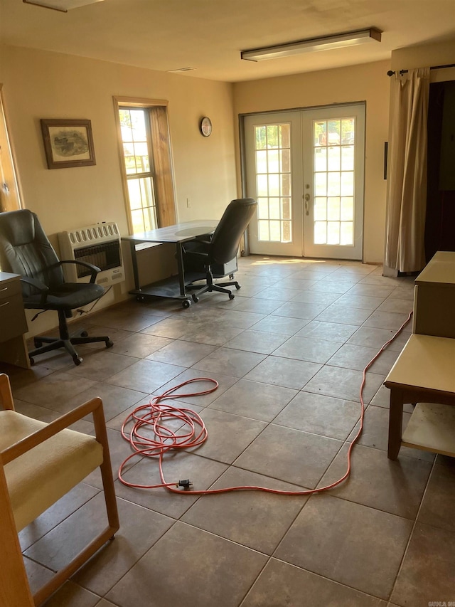 living room with french doors, heating unit, and tile patterned flooring