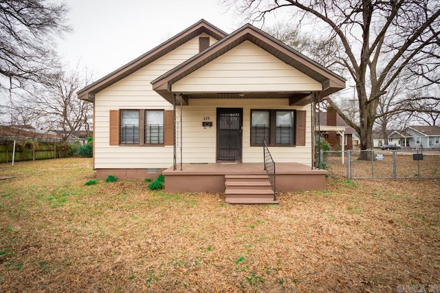 bungalow-style home with a front yard