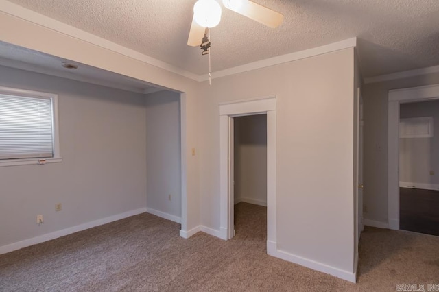 unfurnished bedroom featuring light carpet, ceiling fan, and a textured ceiling