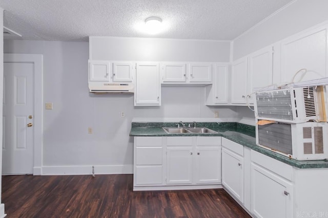 kitchen with dark hardwood / wood-style floors, white cabinets, and sink