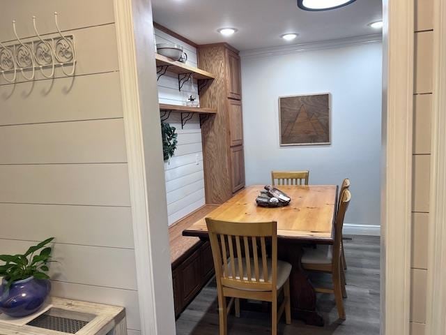 dining area with ornamental molding and dark hardwood / wood-style flooring