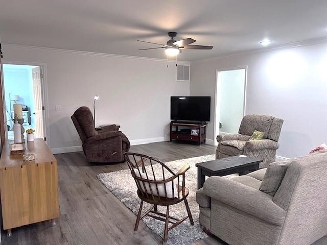 living room featuring ornamental molding, ceiling fan, and dark hardwood / wood-style floors