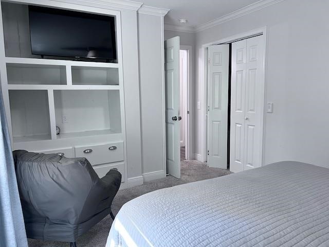 bedroom with ornamental molding and carpet flooring