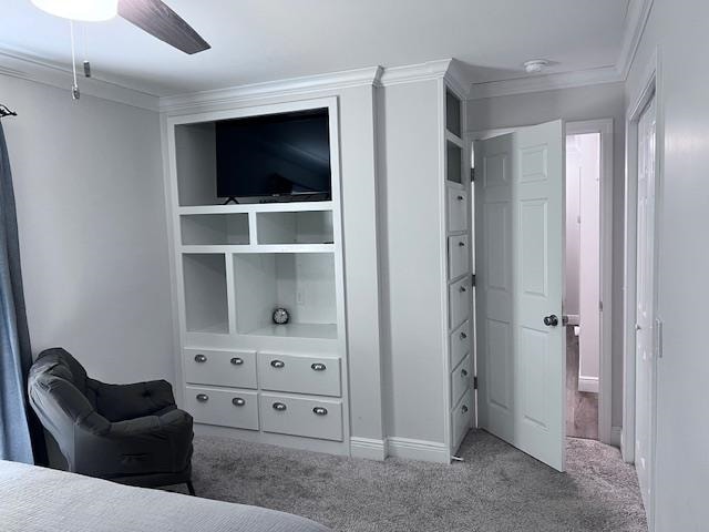 carpeted bedroom featuring ceiling fan and ornamental molding