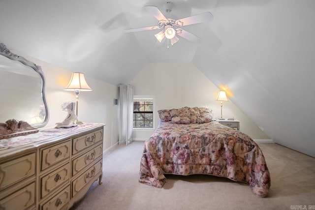 carpeted bedroom with vaulted ceiling and ceiling fan