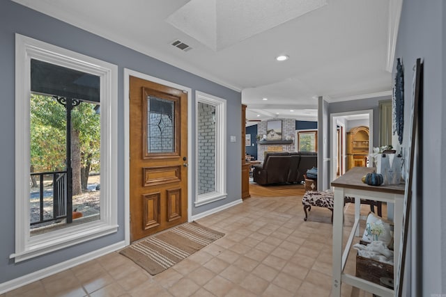 foyer entrance featuring light tile patterned flooring, crown molding, and a textured ceiling