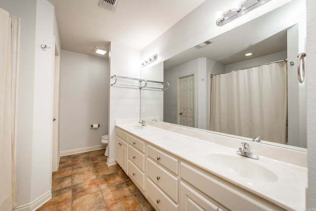 bathroom featuring vanity, tile patterned flooring, toilet, and curtained shower