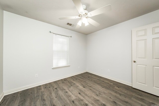 spare room with ceiling fan, dark hardwood / wood-style floors, and a textured ceiling